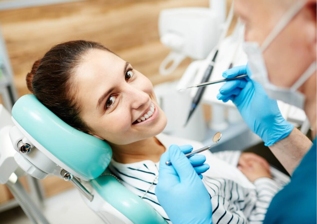 Patient consulting with a dental professional about treatment options, highlighting who does dental implants and the planning process before implant placement.